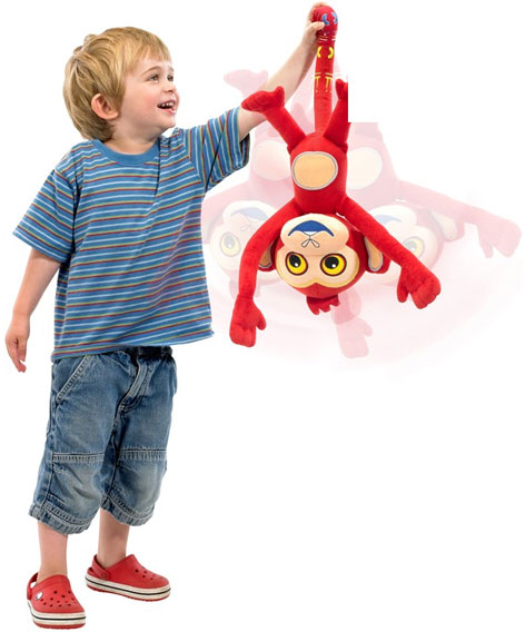A boy playing with his Up, Down and All Around Monkey toy from Tinga Tinga Tales