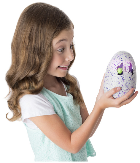 Girl watching her Hatchimals hatch