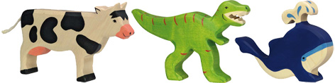 A selection of Holztiger toys - Cow, dinosaur and whale wooden toy figures