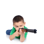 A boy taking aim with a toy gun