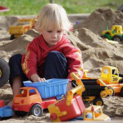 A Little Boy Playing in a Sandpit